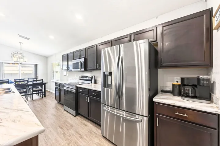 The spacious Kitchen is a welcoming hub for gathering with family and friends.