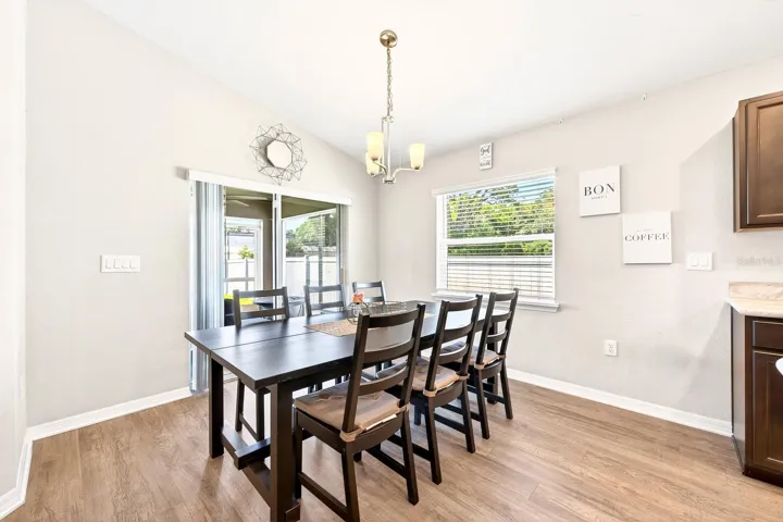 The Dining area is filled with NATURAL LIGHT, enhanced by a large window and sliding glass doors.