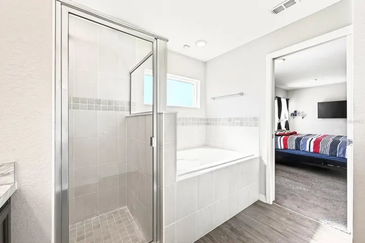 The Primary EN SUITE BATH is complete with dual sinks, a garden tub, a step-in shower, a private water closet, and a SPACIOUS WALK-IN CLOSET.