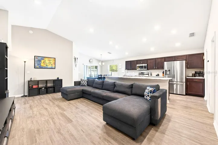 The Living Room, Dining area, and Kitchen flow seamlessly together, creating an inviting space ideal for both relaxing and entertaining.