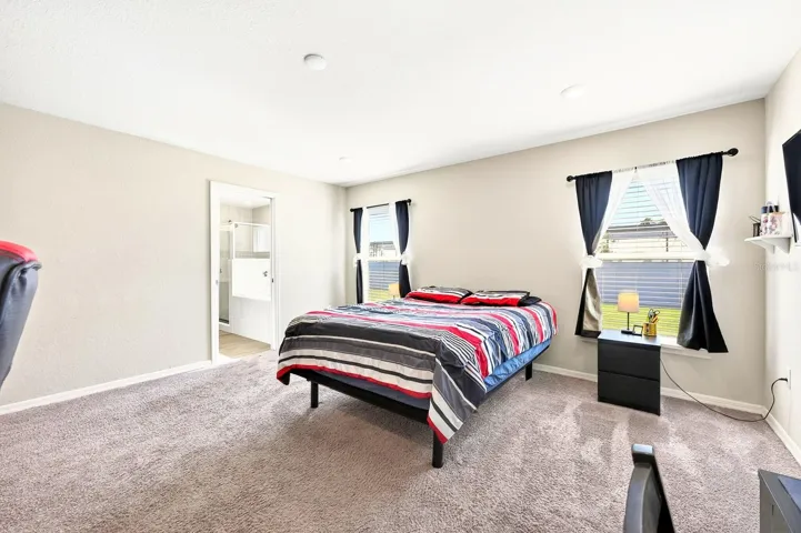 The Primary Suite is a comfortable and private escape, featuring ample NATURAL LIGHT and BACKYARD VIEWS.