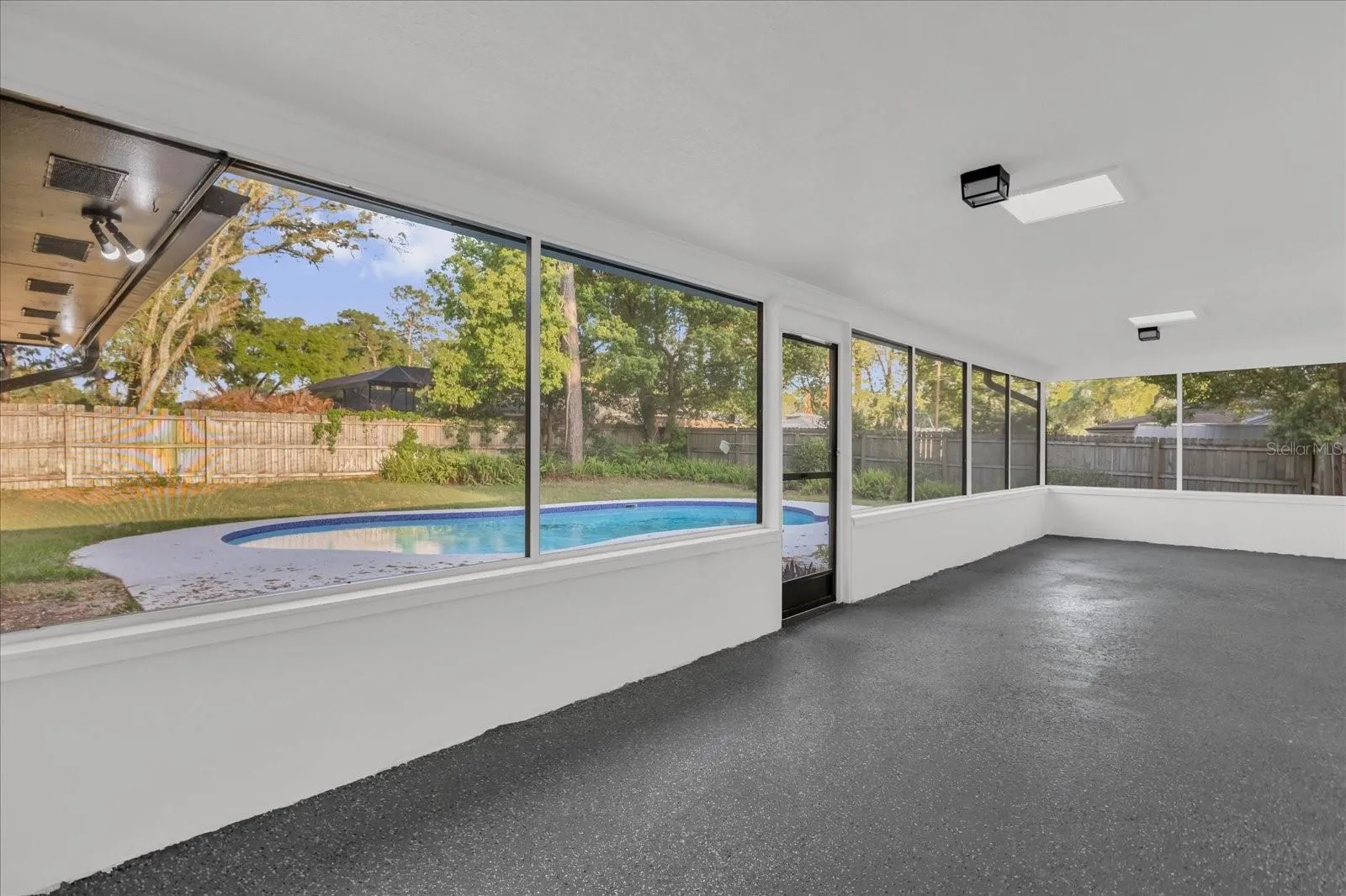The Screened in Porch is  approx 34x10 with an epoxy style floor and great natural lighting. It's easily accessed from many rooms of the home for convenience and is a great place to enetrtain. The flat roof over this portion has been recently redone.