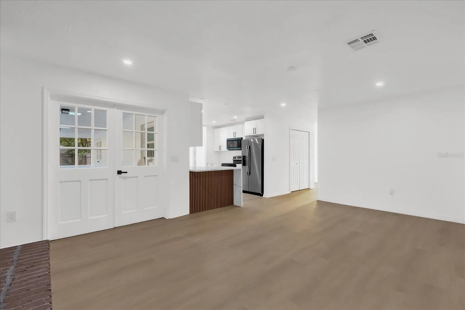 Family room with French Doors to the Patio/ Lanai area and Pool
