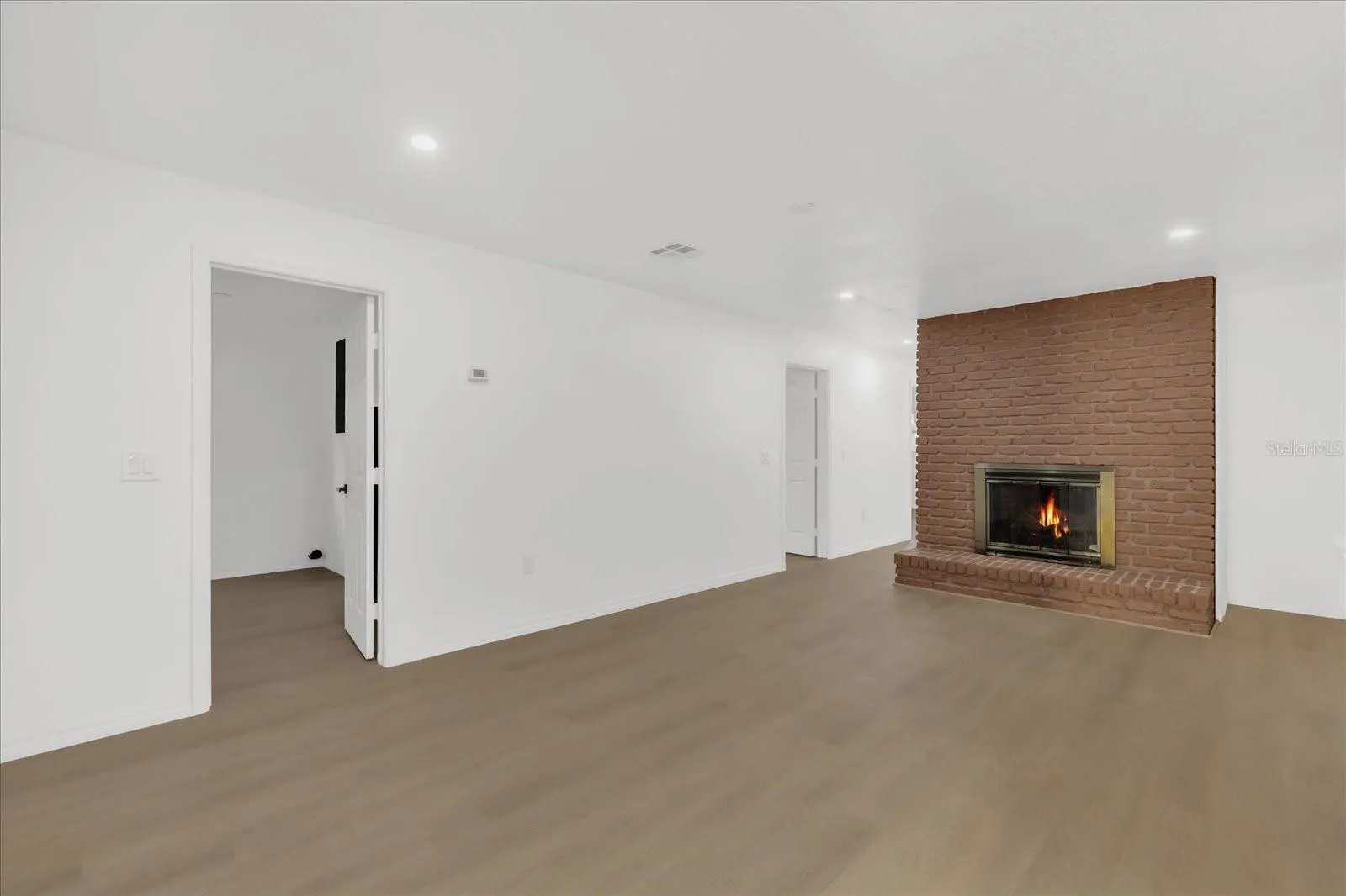 The Family Room is approx 22x13 and is perfectly set up to access the laundry room shown on the left, the Kitchen to the right, and easily leads you to the Lanai and Pool areas. The bedroom are just beyon the fireplace wall.