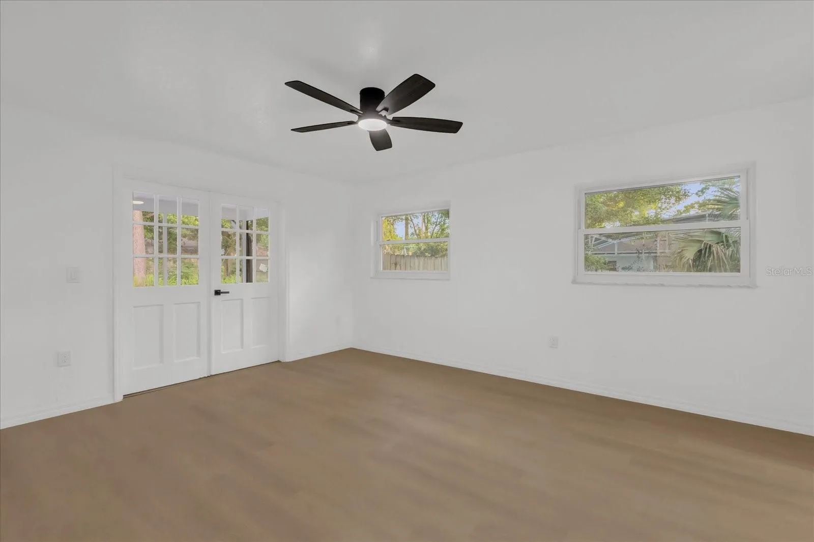Primary bedroom has great natural light and even features french doors in to the large, covered, screened in patio and your private pool. (12x16)