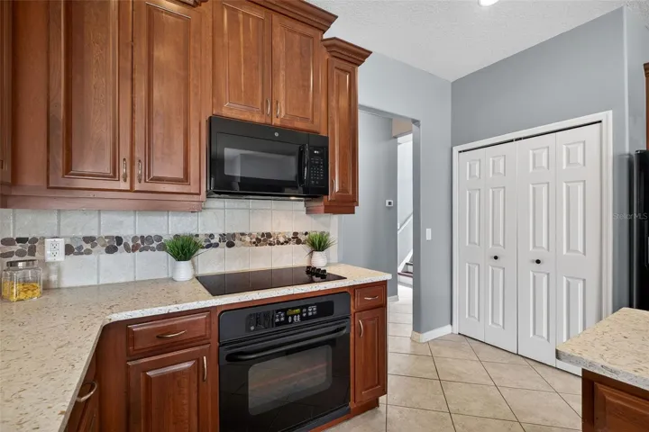 Kitchen with closet pantry and access to staircase leading to 5th bedroom