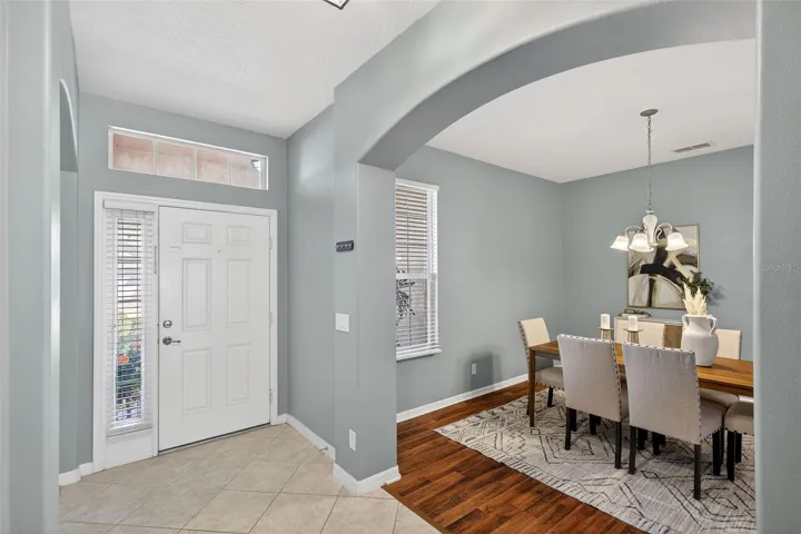 Light and bright foyer with entry to dining room and living room