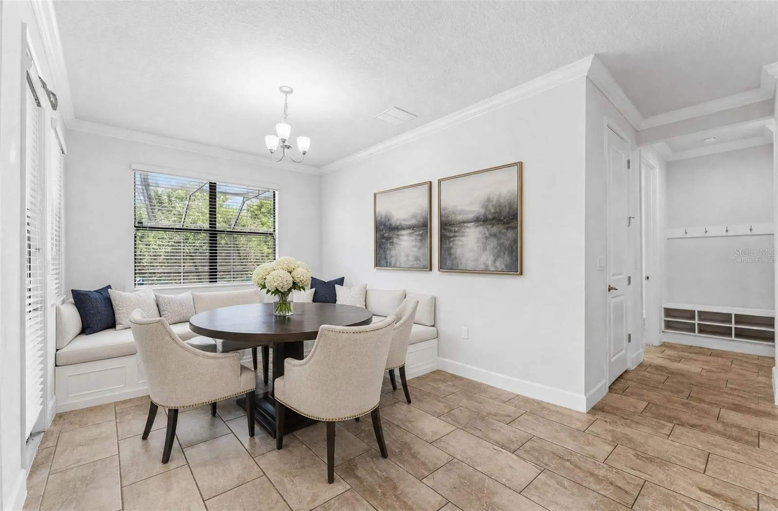 Casual dining off the kitchen in the breakfast nook overlooking the pool with conservation views. Virtually Staged.