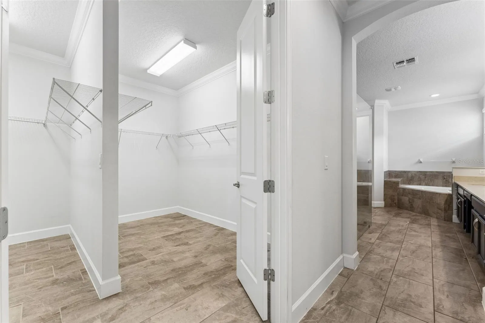 Primary suite dual side walk-in closet.