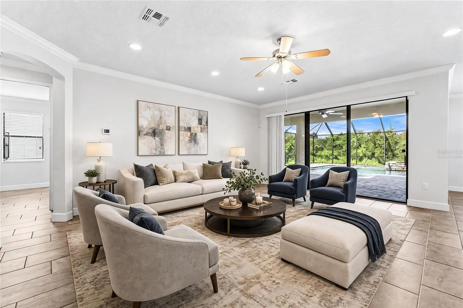 Spaicous living area has a wall of sliding glass doors that open up to the lanai and pool for the ultimate in indoor/outdoor Florida living. Virtually Staged.