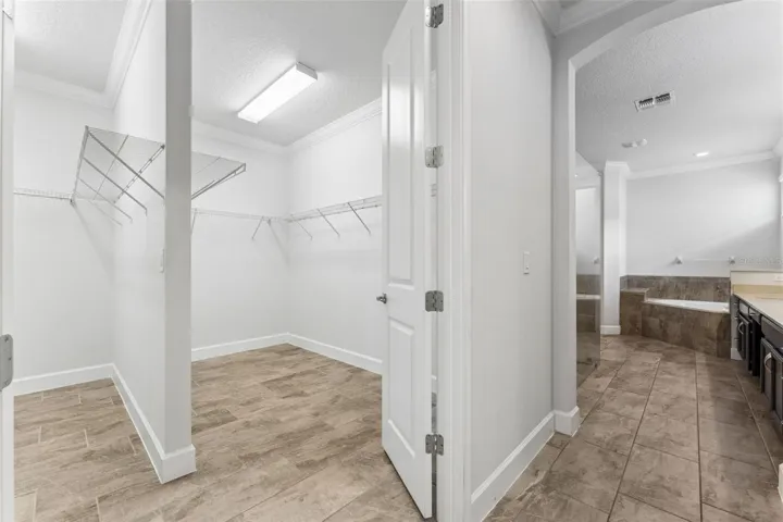 Primary suite dual side walk-in closet.