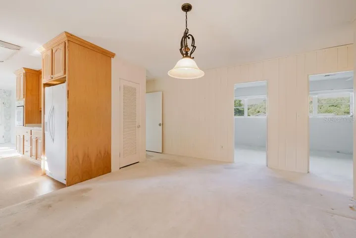 Dining room with view of kitchen and two bedrooms.