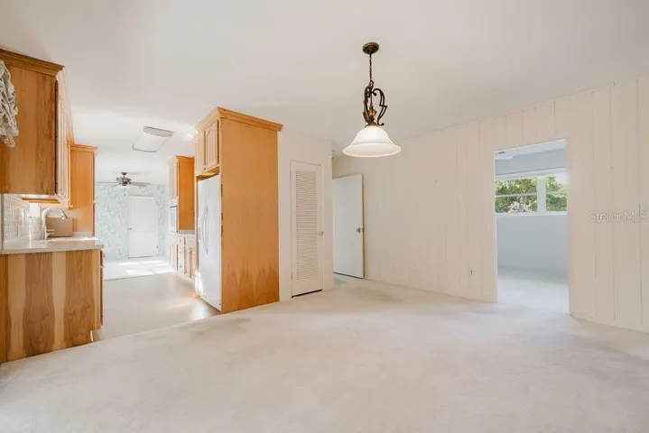 Dining room with view of kitchen and second bedroom.