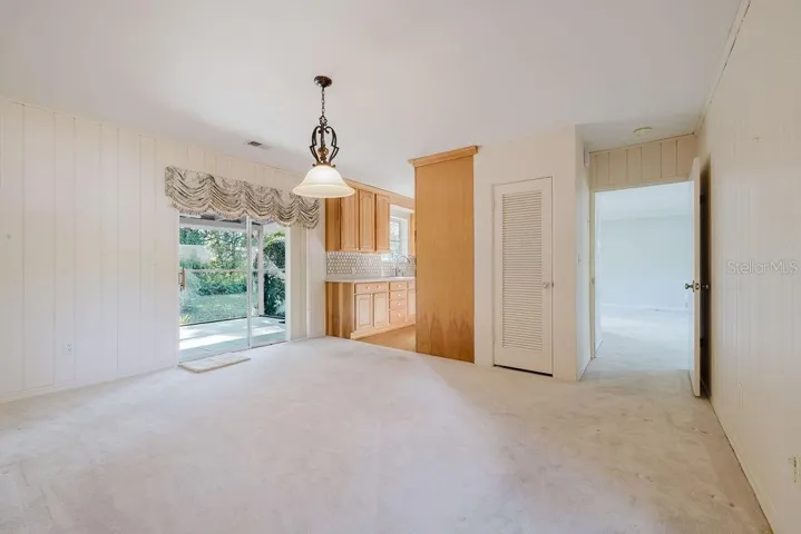 Dining room with view of sliding doors to screened in back porch.