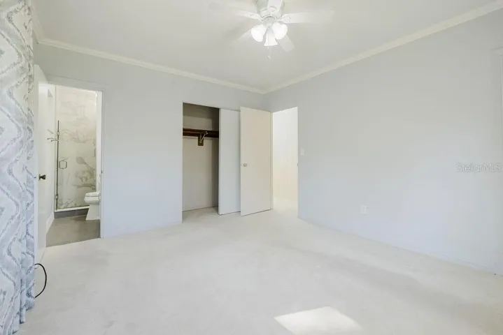 Primary bedroom with ensuite bathroom and built-in closet.
