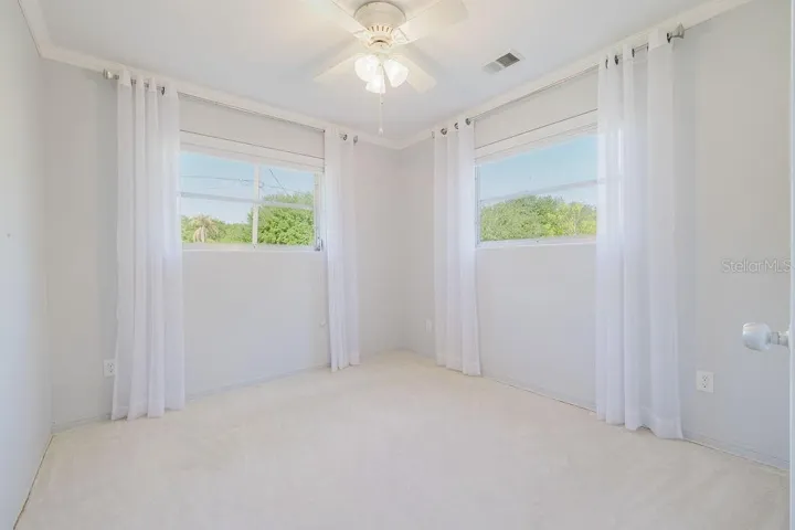 Primary bedroom with ensuite-bathroom and two lovely light-and bright windows. Ceiling fan installed.
