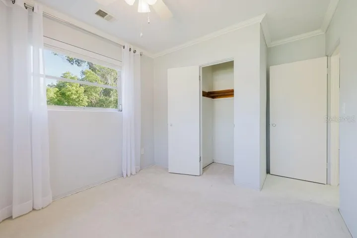 Bedroom 4 with built-in closet and light-and-bright window.