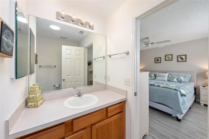 PRIMARY ENSUITE BATHROOM -  Shows glimpse of PRIMARY BEDROOM (on R)
