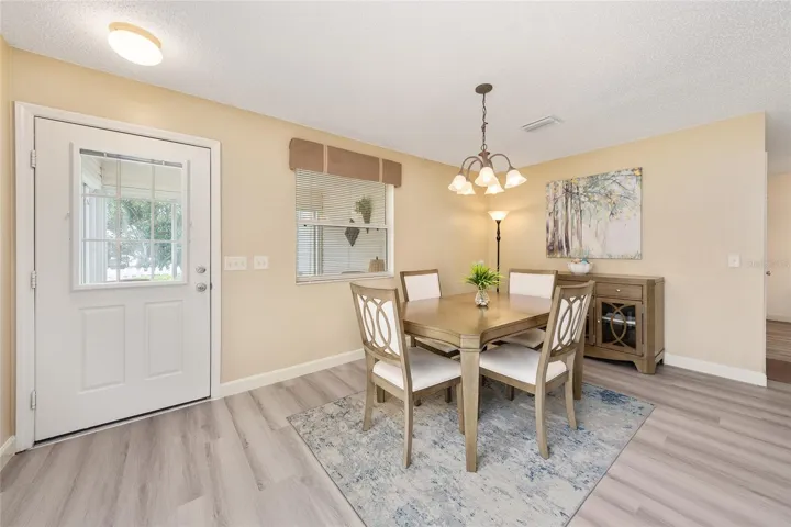 Another view of DINING ROOM includes the back side of the front door.