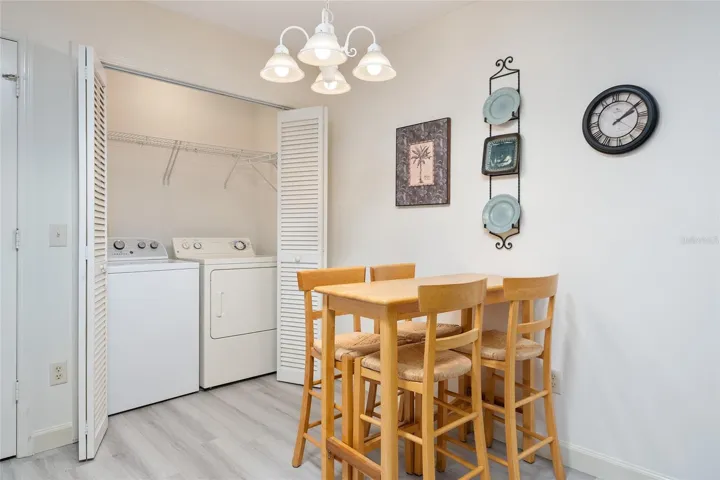 INDOOR LAUNDRY area w/ WASHER/DRYER behind the louvered bi-fold doors in the eat-in area of KITCHEN