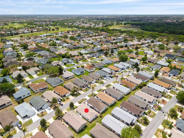 AERIAL looking Southwest - showing close proximity to Buena Vista Blvd in the distance, with easy access to both Lake Sumter Landing and Brownwood Paddock Square, plus Bacall Executive Golf Course at left.