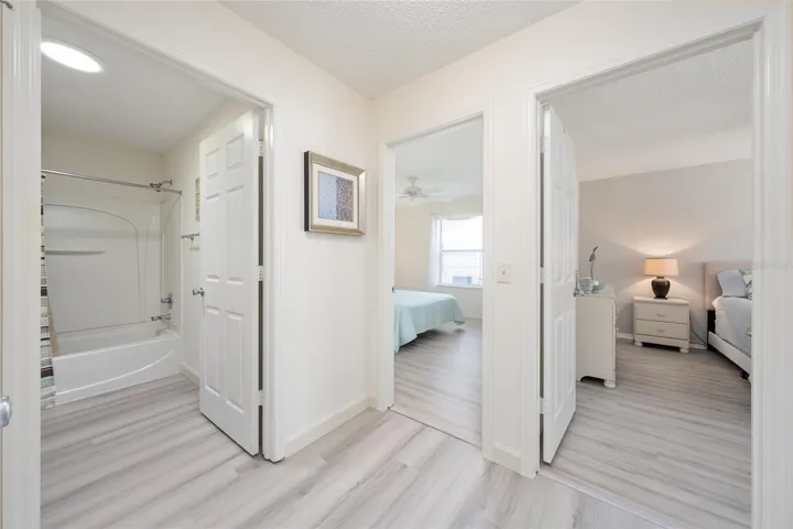 HALLWAY view - Looking into BATHROOM #2 (L), BEDROOM #2 (Center) and PRIMARY BEDROOM (R)