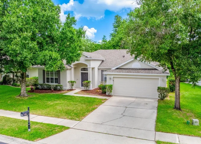 Surrounded by beautiful mature trees in a great East Orlando location - welcome home!