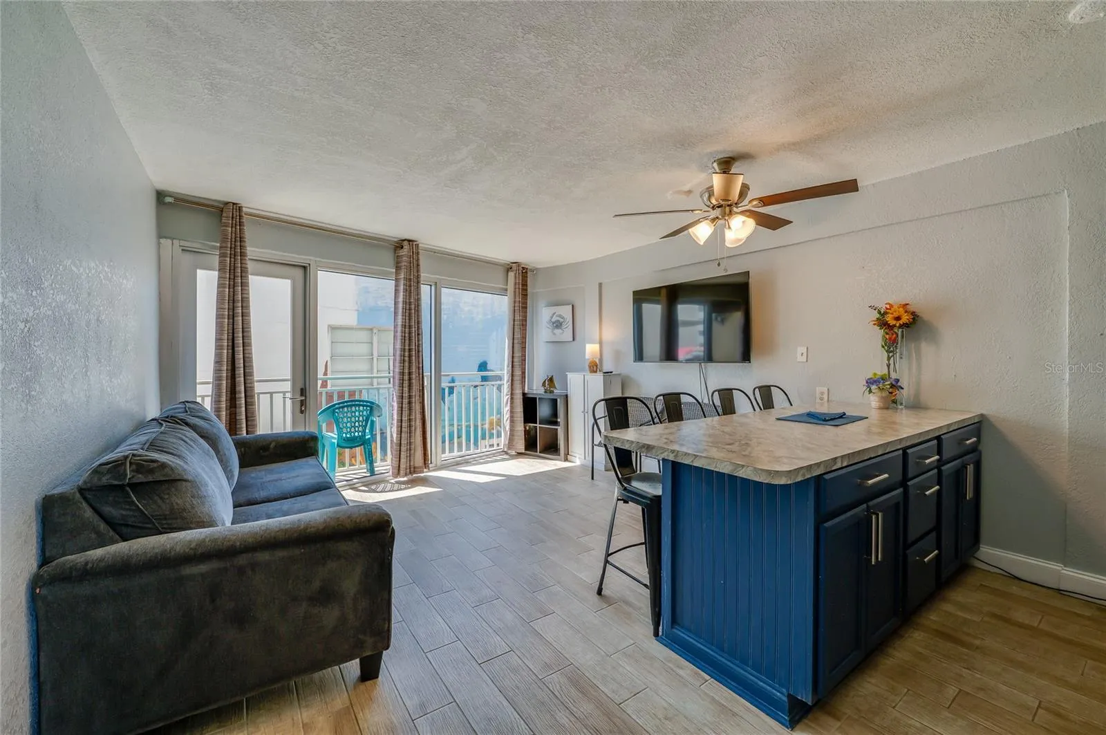 Bright living space with room to lounge and dine, accented by sliding glass doors that bring in natural light and open to a private balcony.