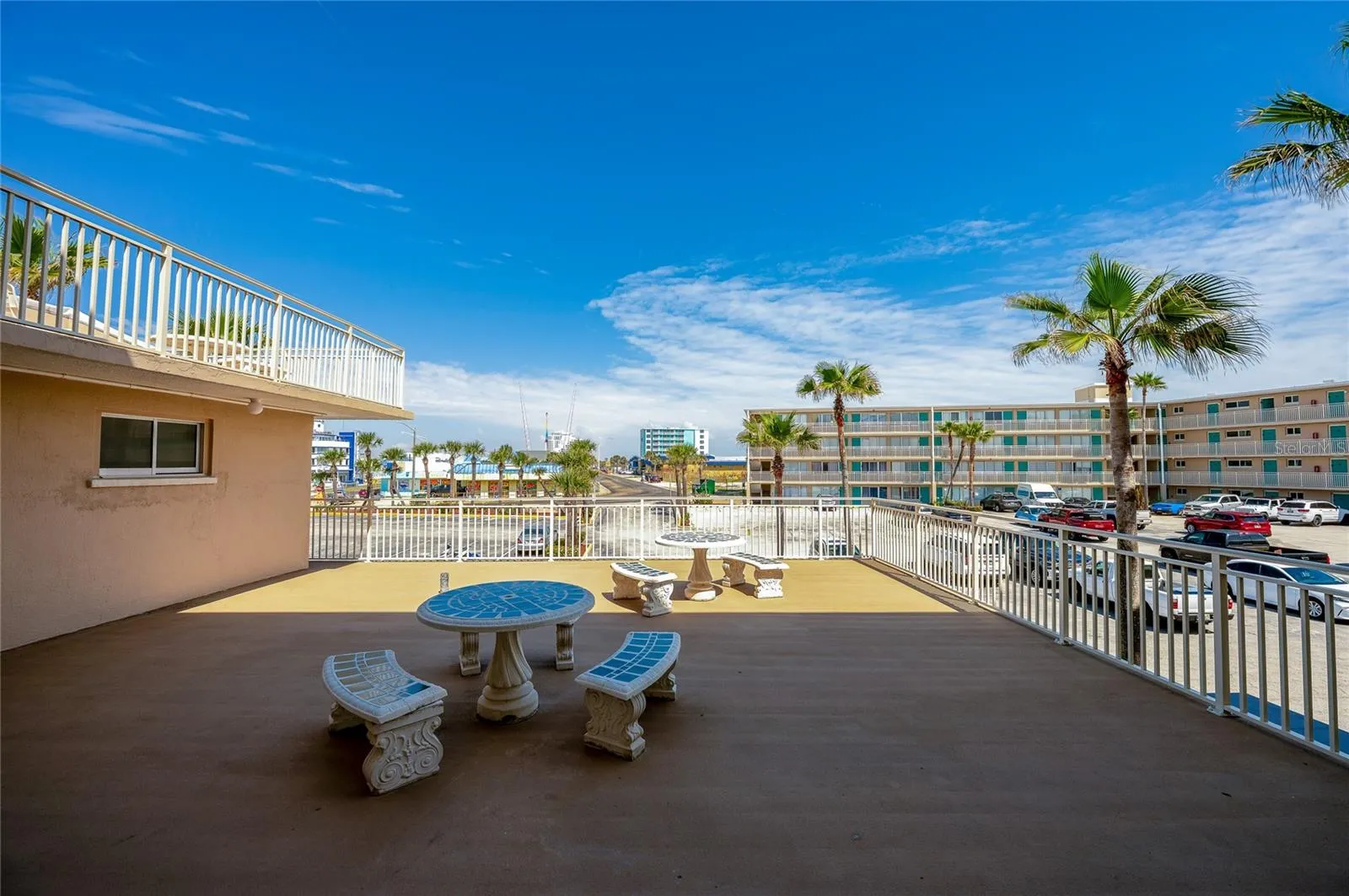 Spacious shared outdoor deck provides room to relax and gather, with open-air seating.