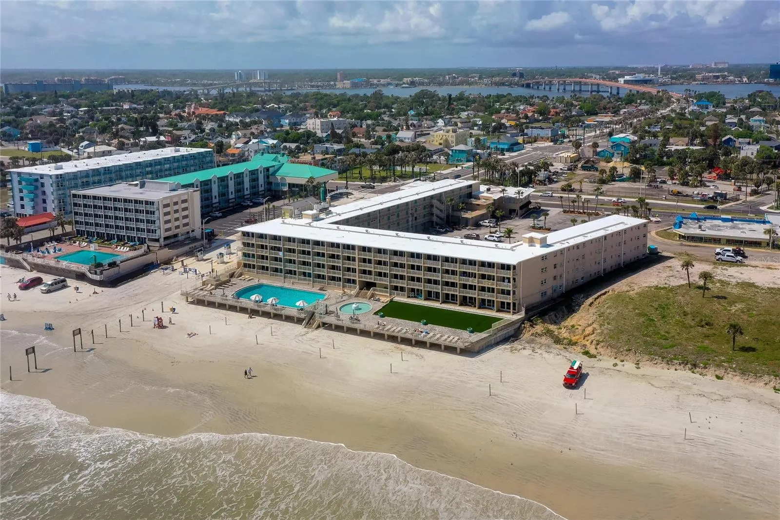 Expansive aerial perspective captures the property’s beachfront footprint and its position close to both the ocean and the mainland side of Daytona Beach.