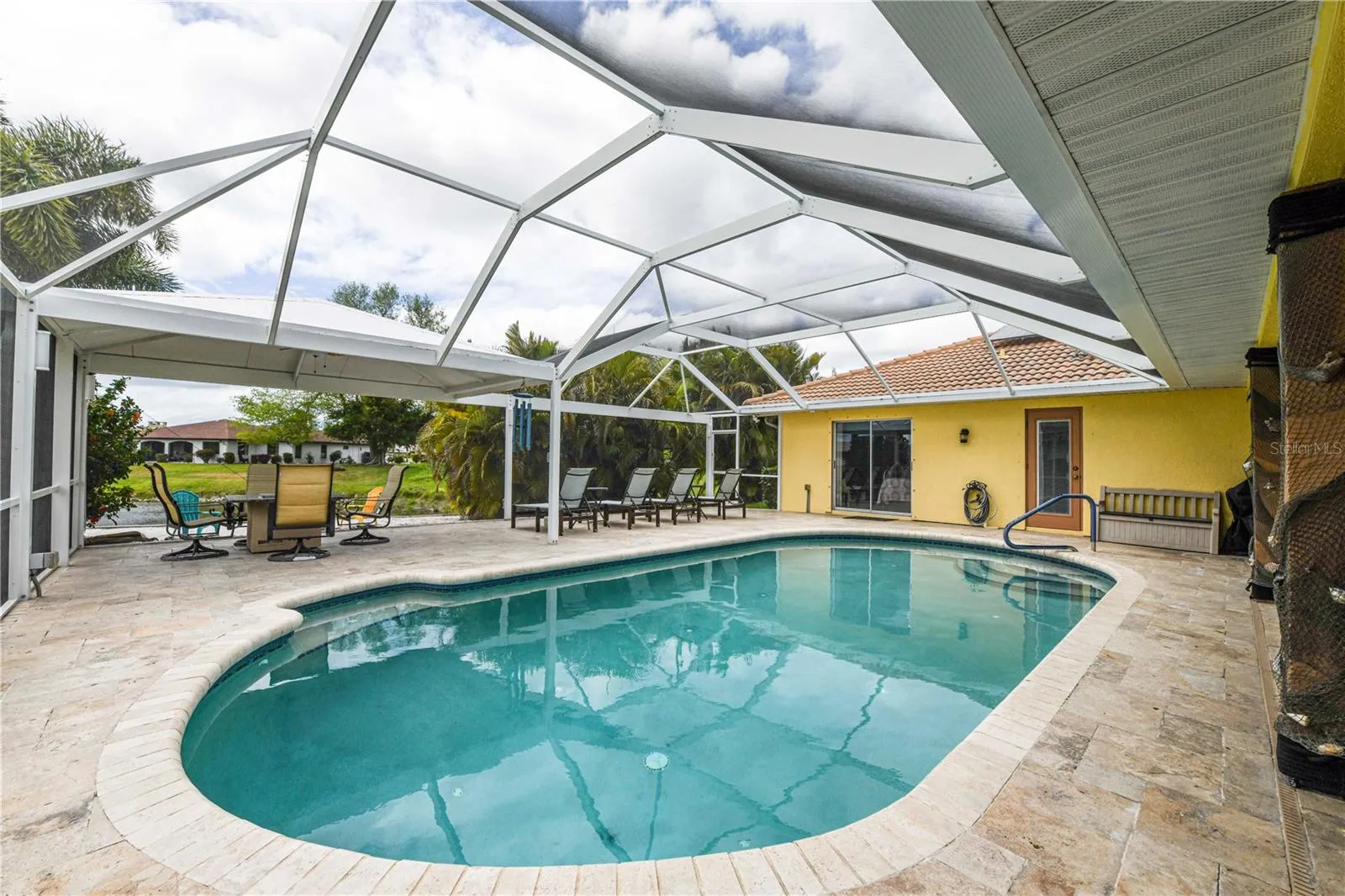 Large pool, fire pit and covered area for the outside kitchen