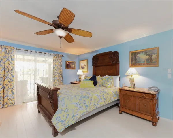 Primary bedroom with sliders to pool area