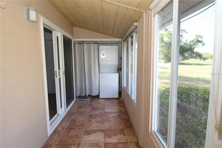 Rear enclosed lanai with Washer/Dryer tucked away.  Beautiful pavers and pretty view make this lanai the perfect place for morning coffee.