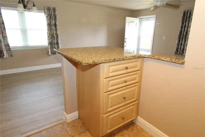 Added counter/cabinet space in kitchen, next to the dining area.