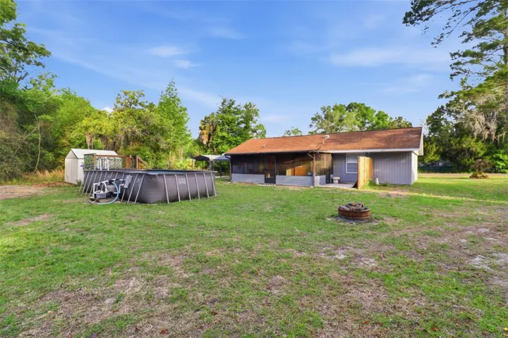 Rear view of home, pool and shed