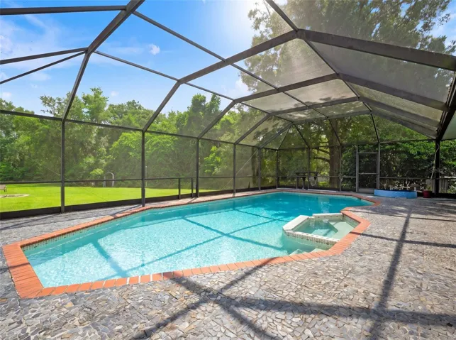 Screened Pool and Spa Surrounded by Mature Trees