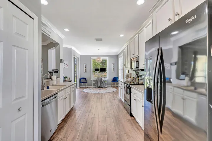 Kitchen area facing into kitchen nook which is back of home