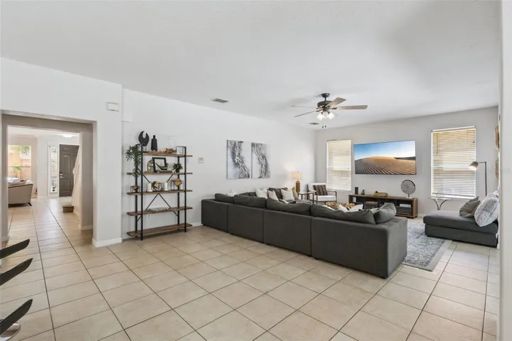 Second living space open to kitchen with TV and room for a large family to relax or entertain.
