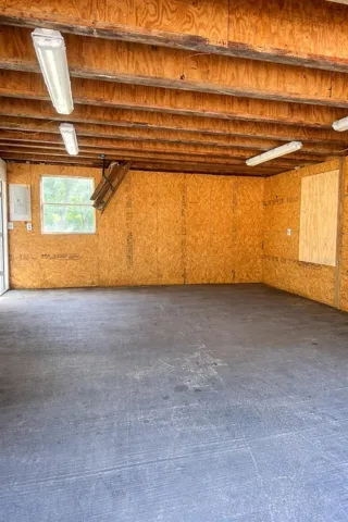 Interior of workshop. Loft/Attic access via pull-down attic ladder (depicted in photo in back)