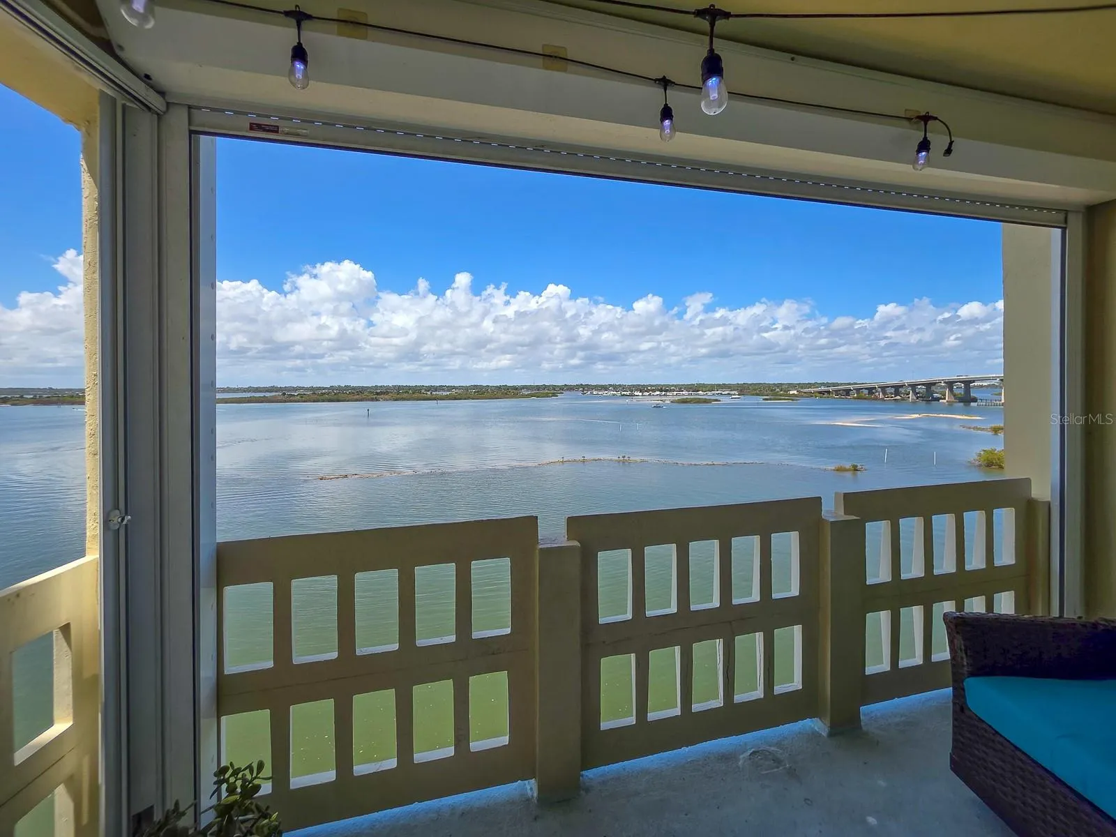 Covered balcony with electric storm shutters.