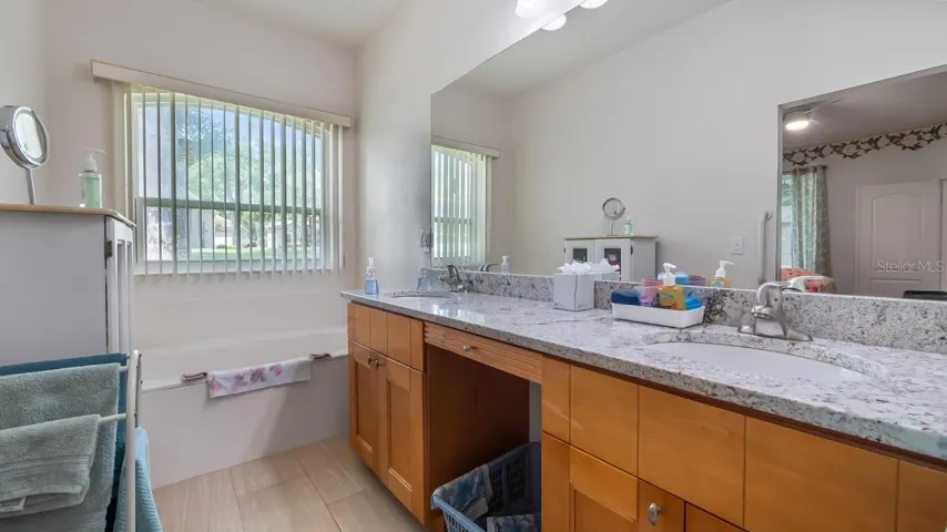 Primary Bathroom With Newer Cabinets and Granite Counter Tops