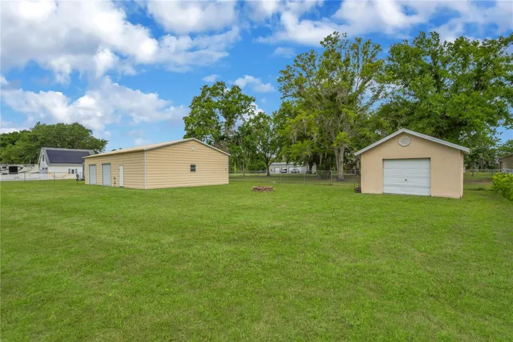 The 12x16 detached shed has a manual garage door to provide additional storage for lawn equipment and tools.  Inside there is a concrete slab and no electric or water.