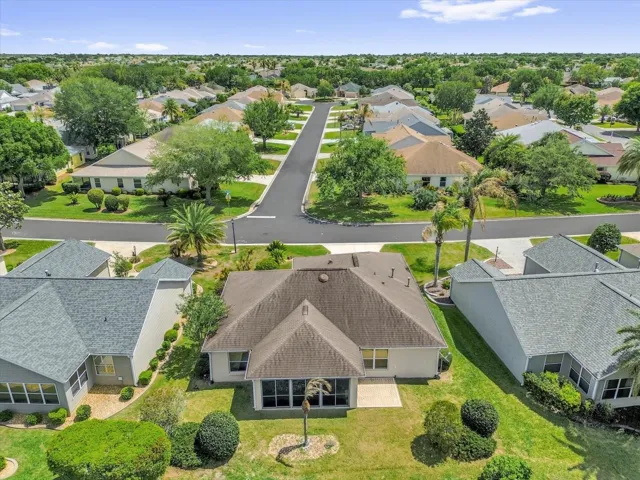 Overhead view showcasing the home’s footprint, outdoor living areas, and surrounding neighborhood.