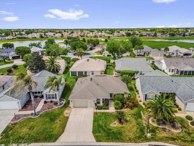 Bird’s-eye view highlighting the home’s position within a beautifully maintained community near scenic water features.