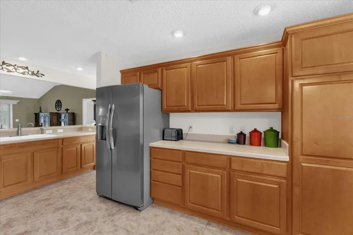 Bright kitchen with ample cabinet storage, counter space, and open layout connecting to the main living areas in this Villages home.