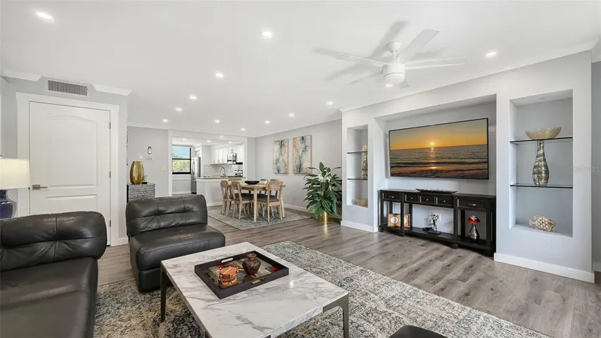 Living room with recessed illuminated glass shelves