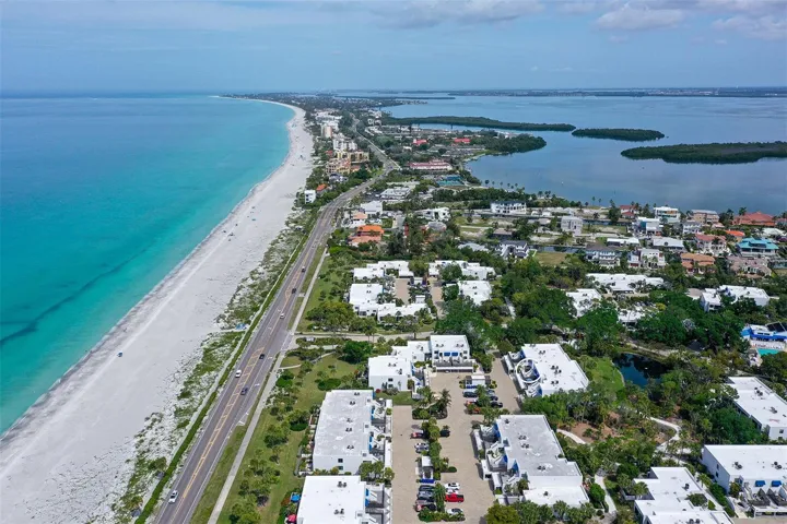 Steps to the deeded beach with umbrellas and lounge chairs