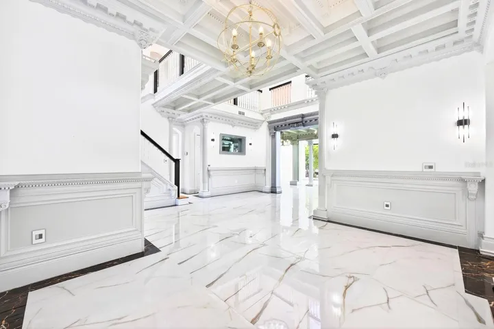 The formal dining room flows into a formal living space.