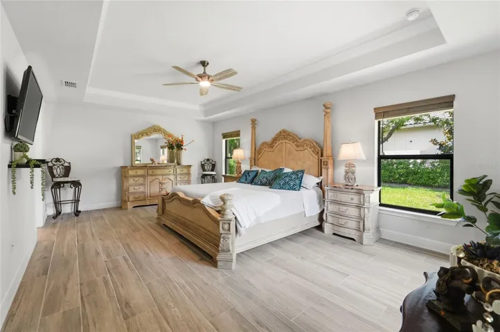 Primary bedroom, All tile flooring with a exit to the enclosed patio.