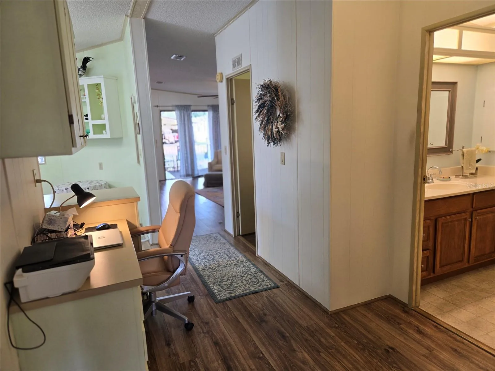 Hallway office opens to laundry rooom